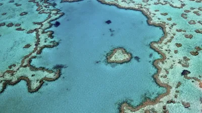 Luftaufnahme des Great Barrier Reefs mit türkisfarbenem Wasser.