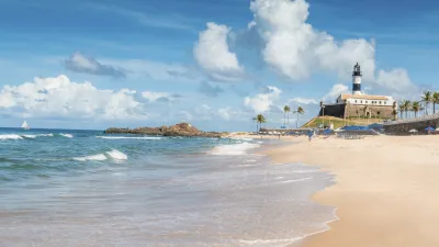 Strandlandschaft mit Leuchtturm und Palmen in Salvador, Brasilien