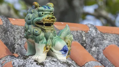 Traditionelle grüne Löwenstatue auf einem japanischen Dach