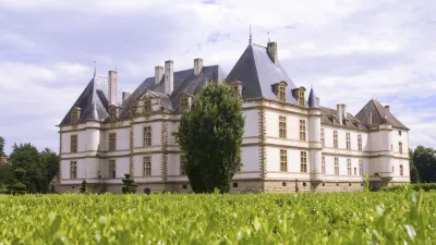 Schloss Cormatin erhebt sich majestätisch vor grünen Feldern.