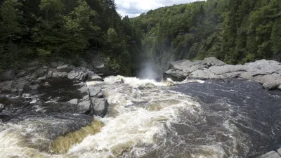 Wilder Wasserfall stürzt über Felsen in einem tiefen Canyon.