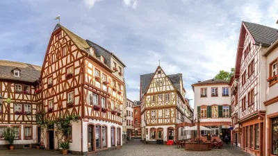 Historische Fachwerkhäuser säumen eine gepflasterte Gasse in Mainz.