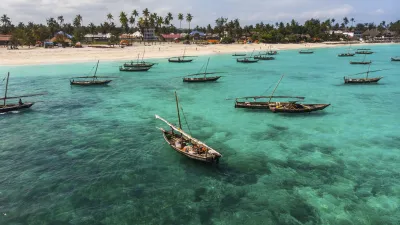 Traditionelle Fischerboote treiben im türkisfarbenen Wasser Sansibars.