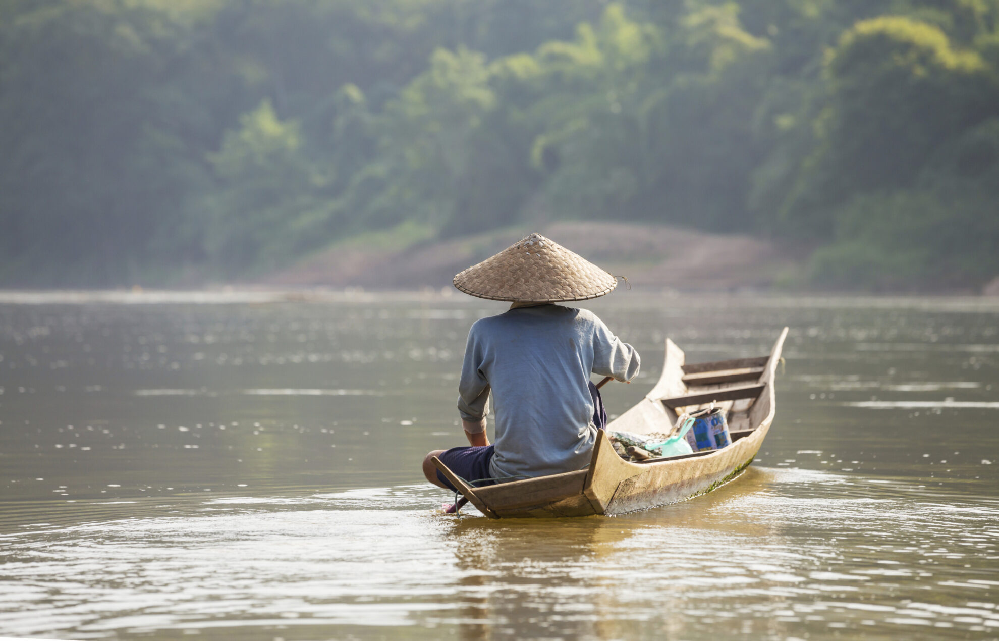 Einheimischer auf einem Holzboot in der Provinz Luang Prabang, Laos